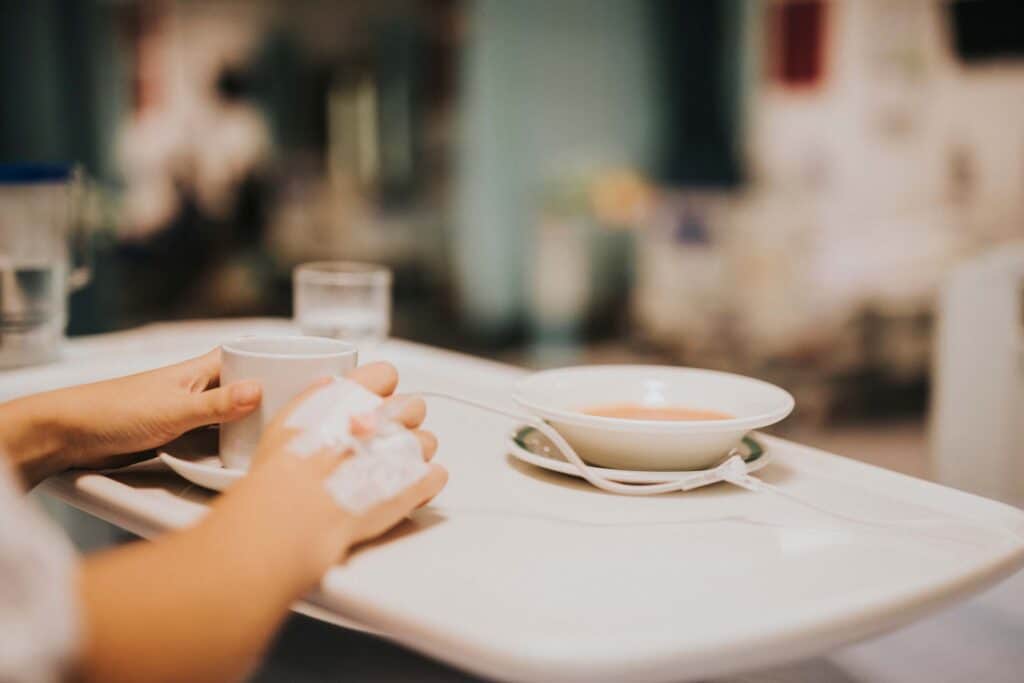 Patient having a light meal in her hospital bed